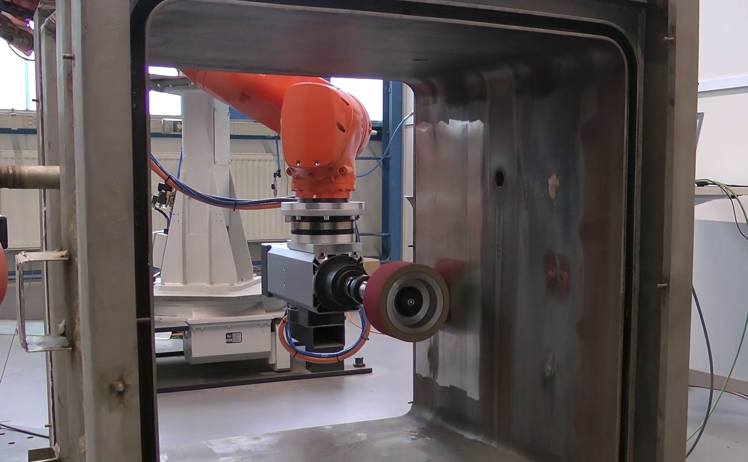 An industrial robot grinding a metal surface
